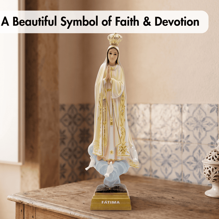 A religious statue of Our Lady of Fatima standing on a cloud, with a gold base labeled &