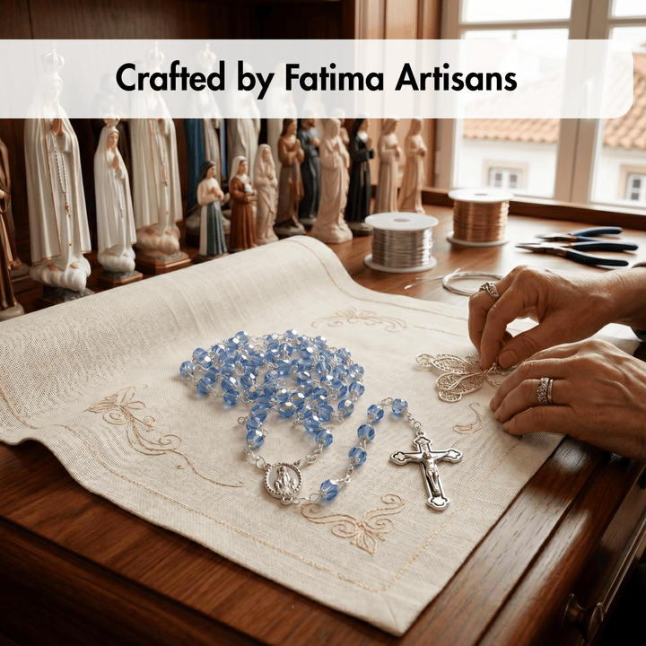 Person working on a rosary with statues in the background, labeled 'Crafted by Fatima Artisans'.