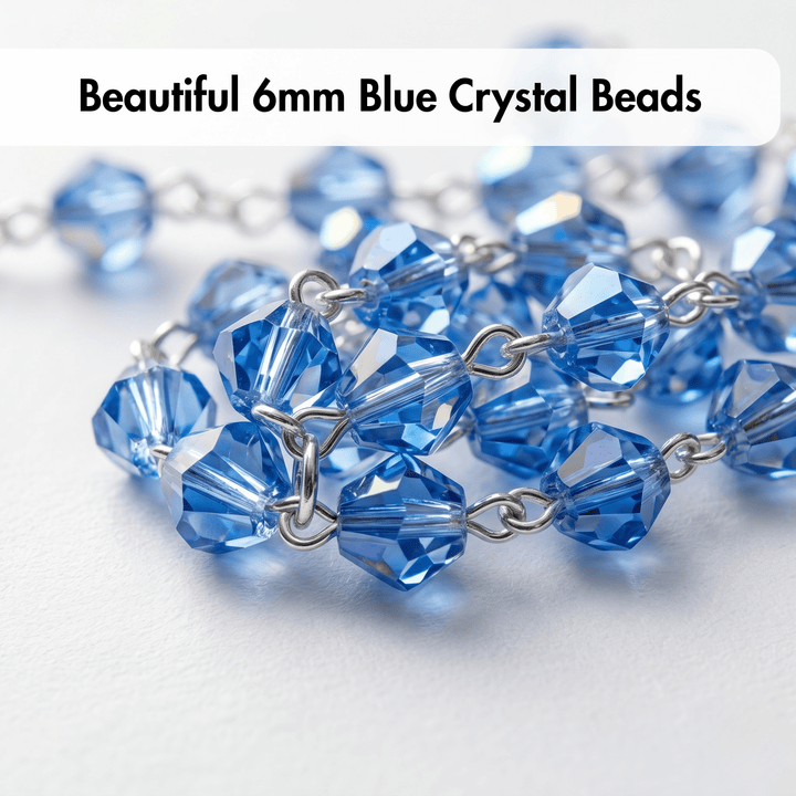 Close-up of blue crystal beads with silver chain on a light background