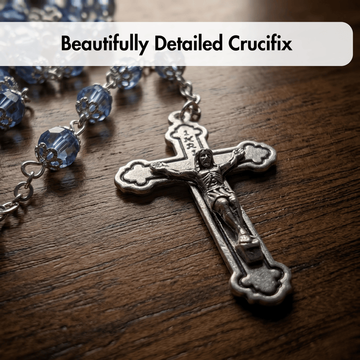 Detailed crucifix on a wooden surface with blue beads