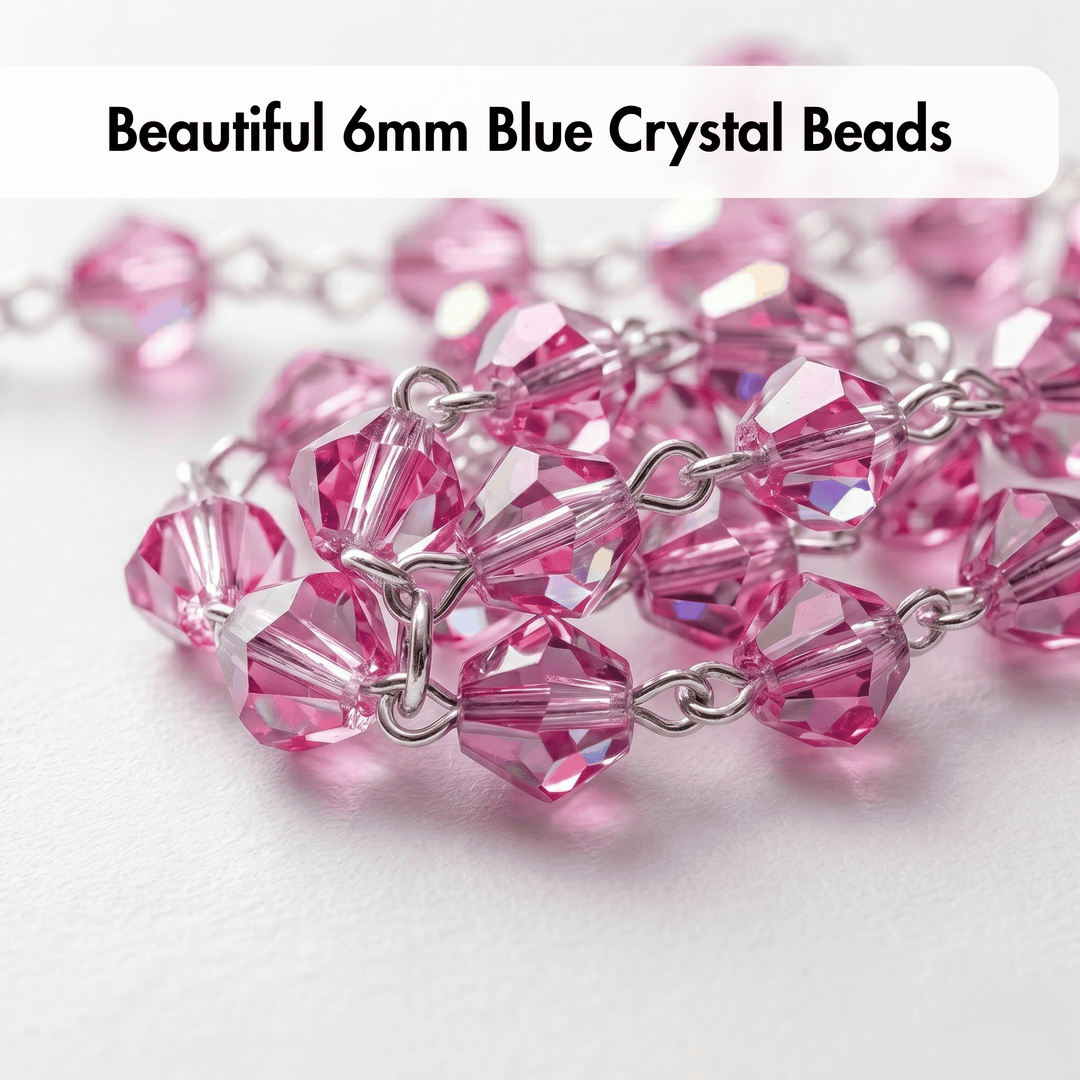Close-up of pink crystal beads with silver chain on a white background