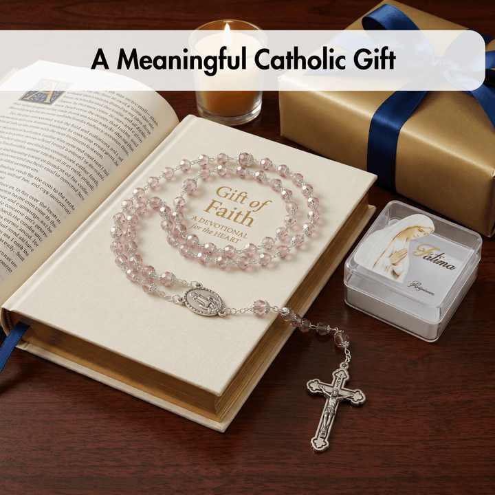 Catholic gift set with rosary, book, and box on a wooden surface