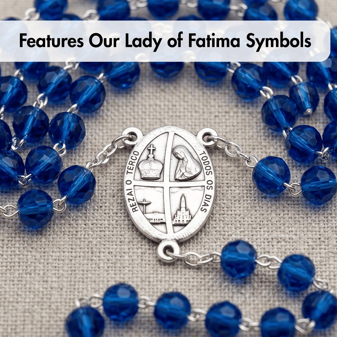 Blue rosary with silver Our Lady of Fatima symbols on a textured fabric background