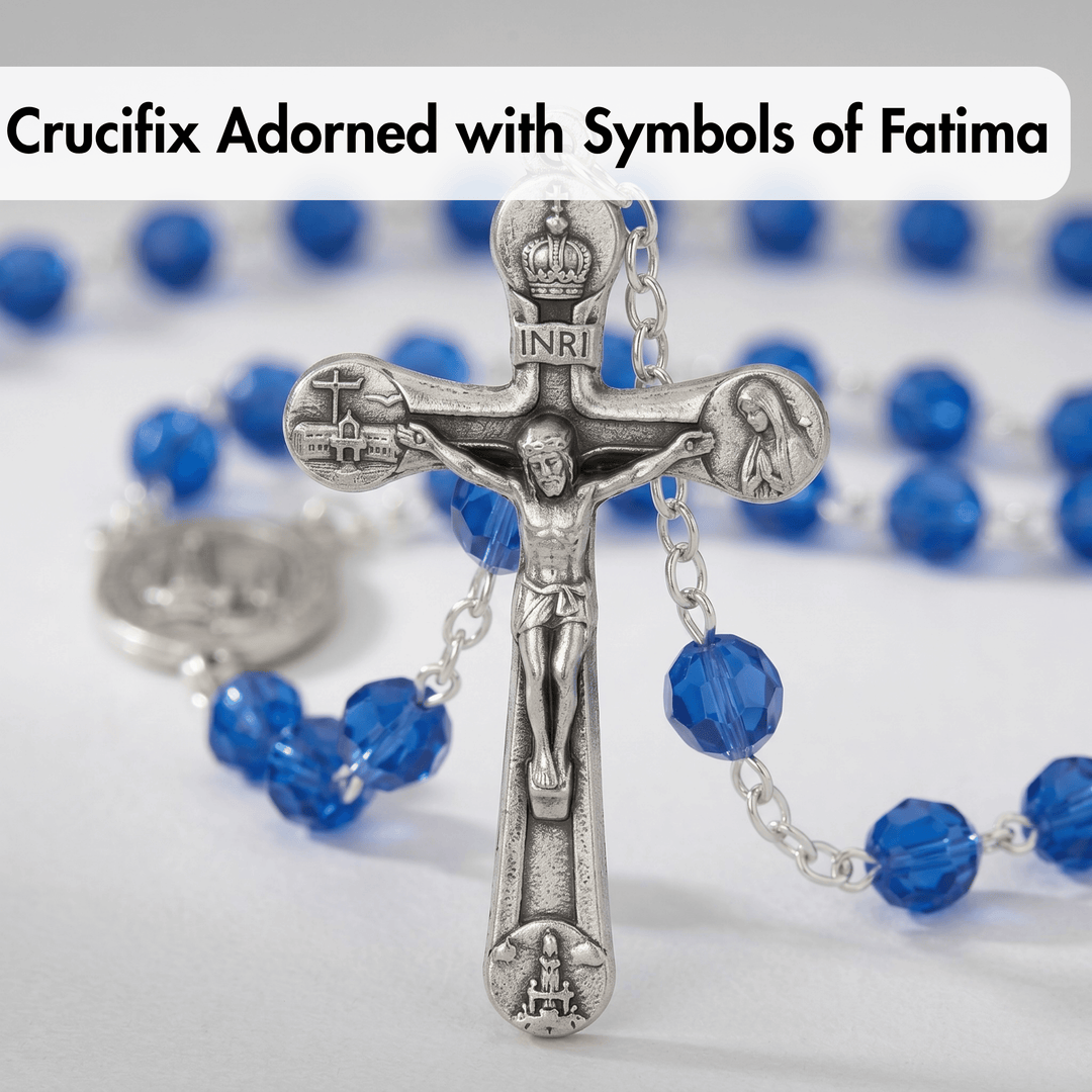 Silver crucifix with blue beads on a white background