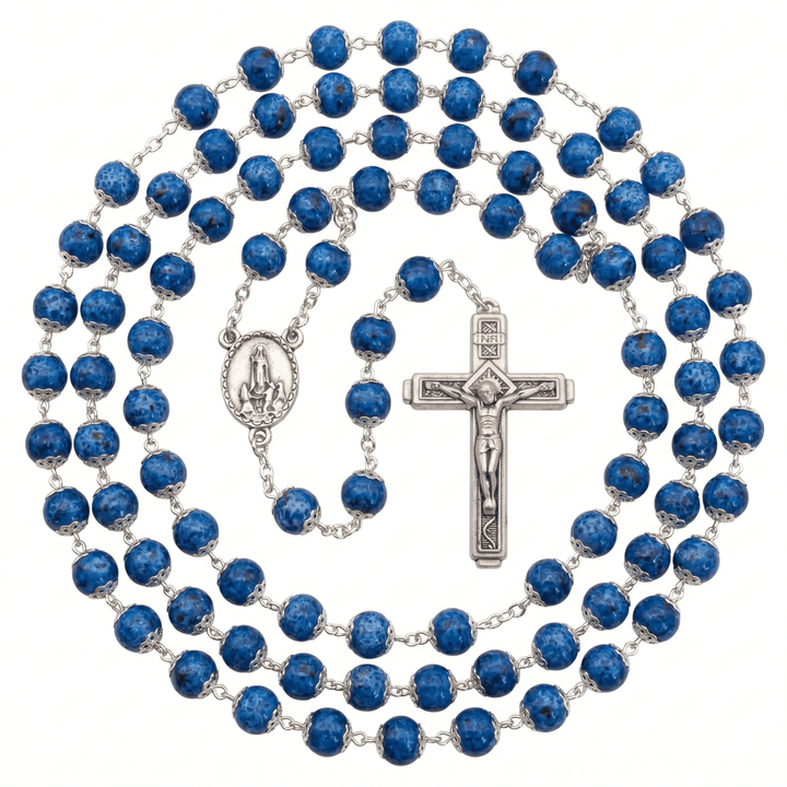 Blue rosary with silver cross and medal on a white background