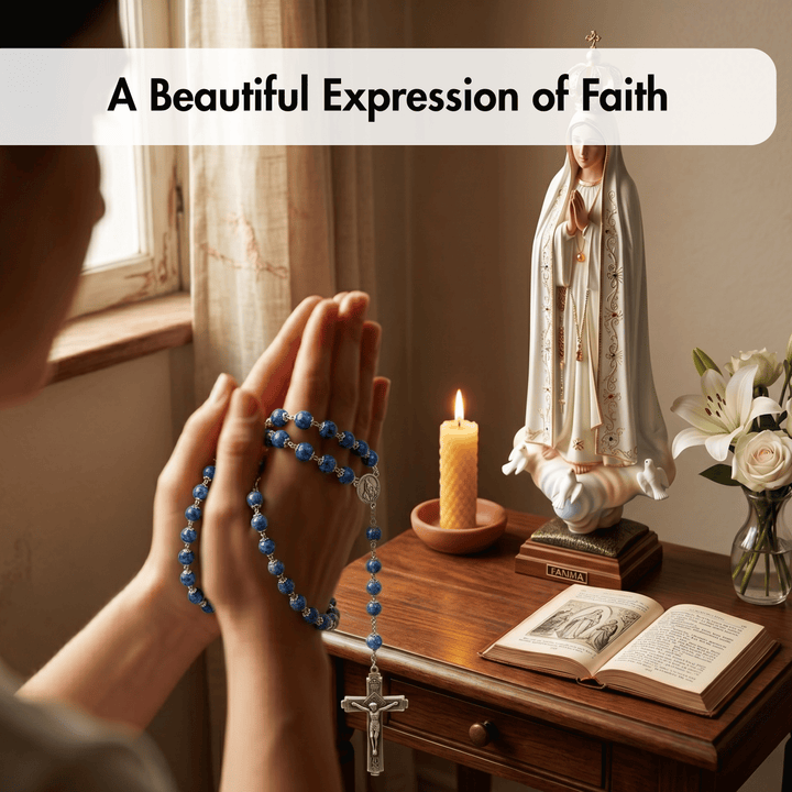 Person praying with a rosary, candle, and statue of a religious figure on a table.