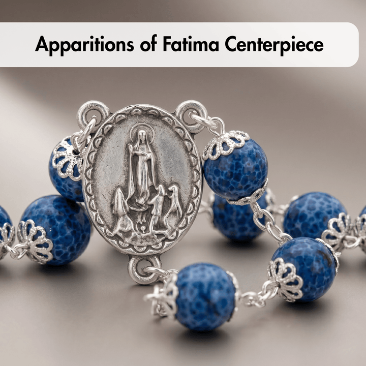 Blue and silver Rosary with central medallion on a neutral background
