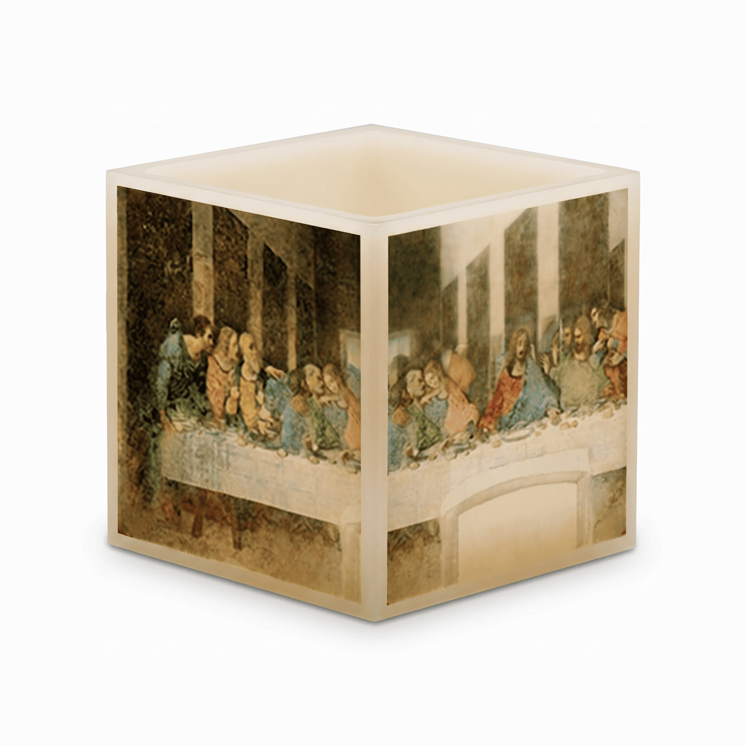 A cube-shaped lamp with a printed depiction of Leonardo da Vinci's Last Supper on the exterior, shown against a plain white background.