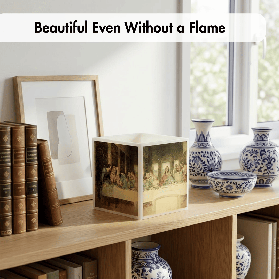 A square decorative box with a classical painting print on its sides sits on a wooden shelf beside books, a framed print, and blue-and-white ceramic vases. Text at the top reads &