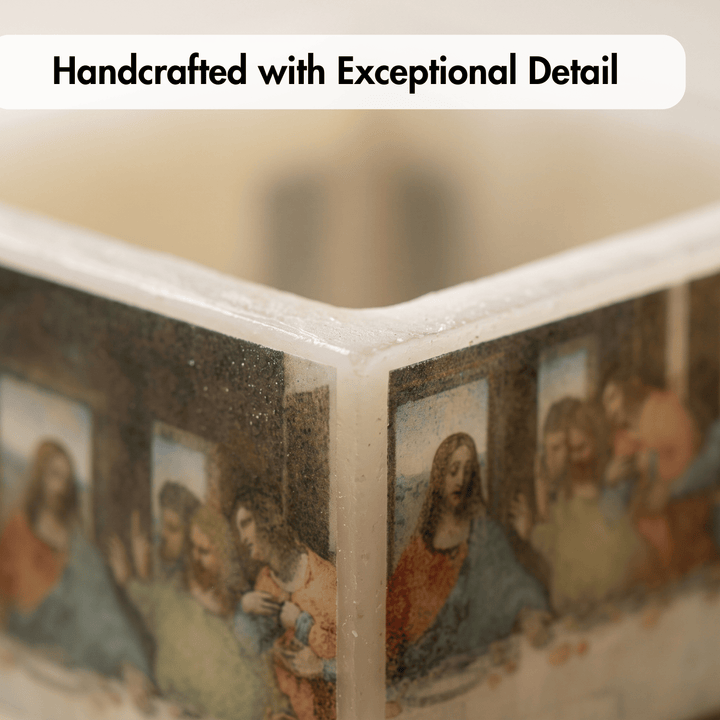 Close-up of a clear acrylic block with printed artwork depicting a religious scene, with the text &