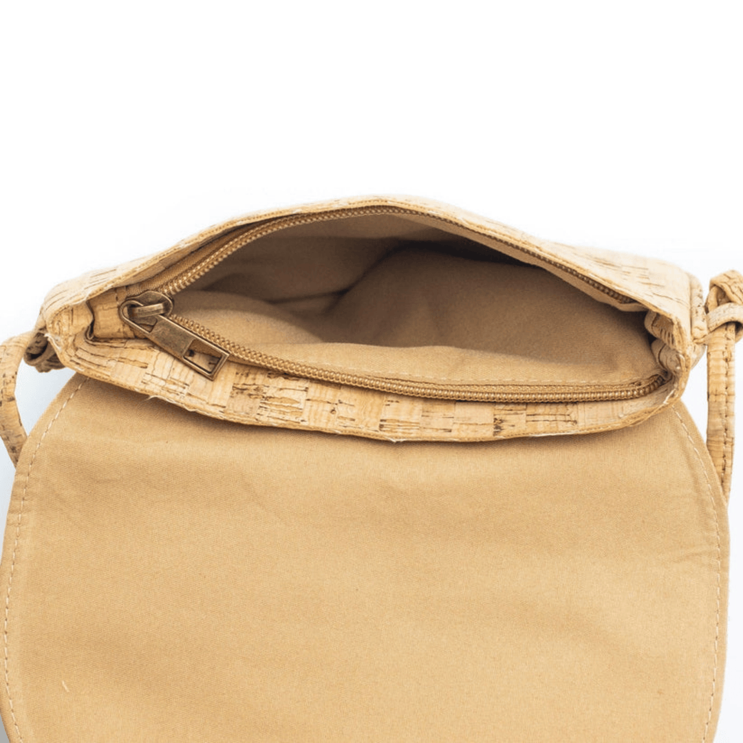 Beige handbag with cork accents on a white background