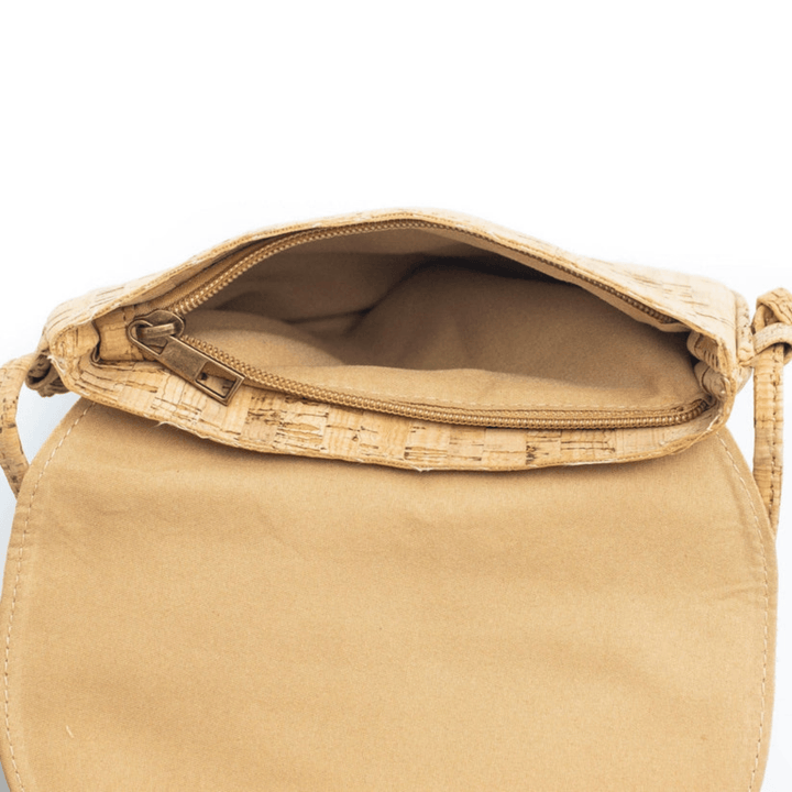 Beige handbag with cork accents on a white background