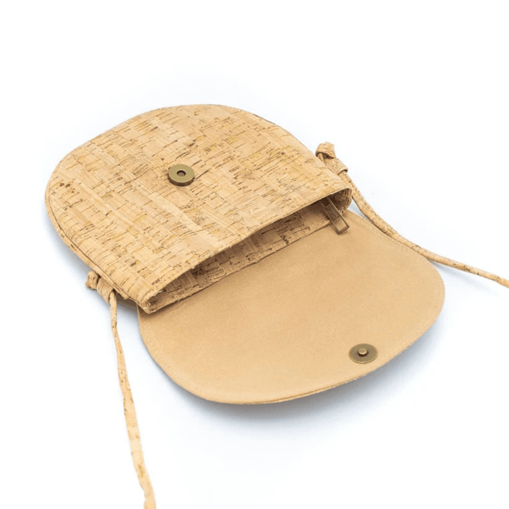 Beige cork handbag with a strap on a white background