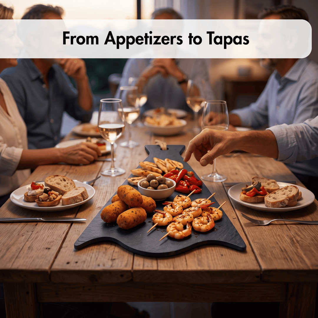 A dining table scene with a large black serving platter filled with appetizers and tapas, including shrimp skewers, potato balls, bread, olives, and sliced red peppers. Several people are seated around the table with wine glasses, and a banner at the top reads &