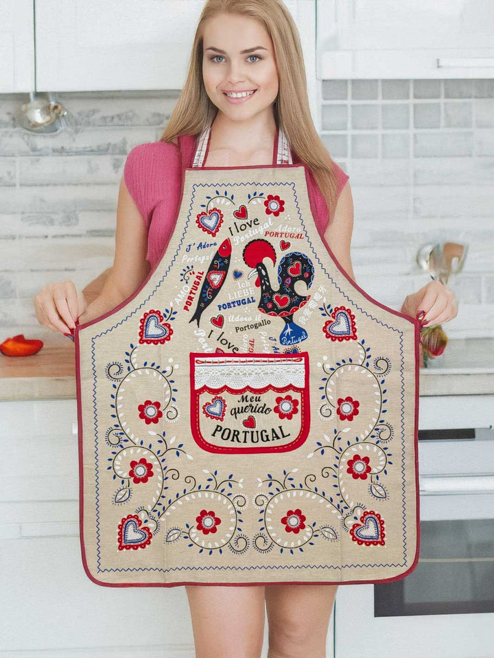Woman wearing a decorative apron with Portuguese designs in a kitchen.