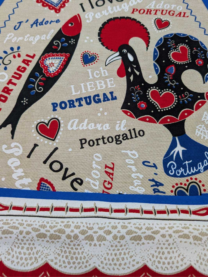 Decorative fabric with rooster design and text 'I love Portugal' in multiple languages.