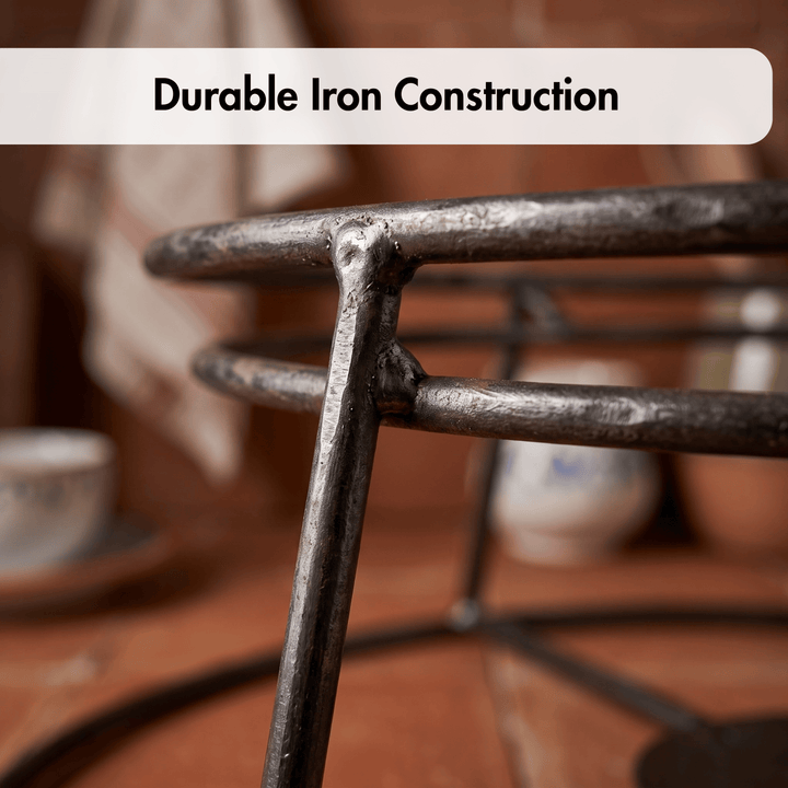Close-up of a dark iron metal frame with overlaid text reading &