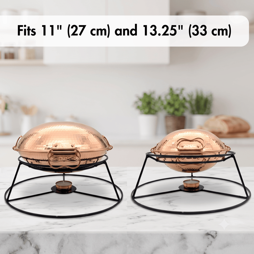 Two copper chafing dishes on black metal stands, shown on a marble countertop with a blurred kitchen background. Text at the top reads &