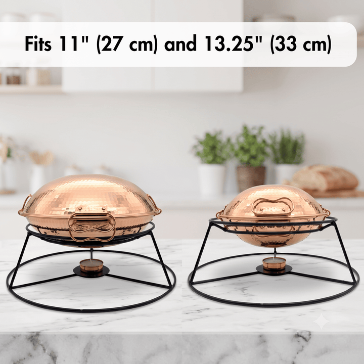 Two copper chafing dishes on black metal stands, shown on a marble countertop with a blurred kitchen background. Text at the top reads &