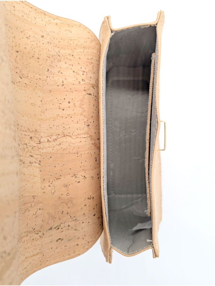 Cork clutch bag with a textured surface on a white background