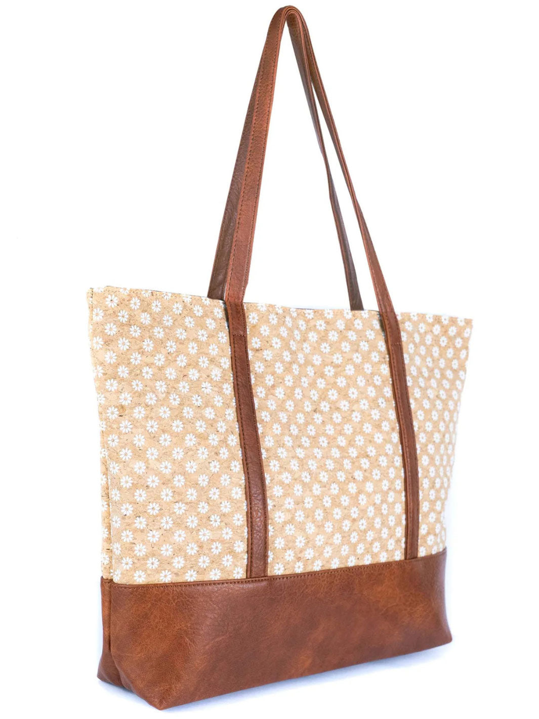 Tote bag with floral pattern and brown leather accents on a white background