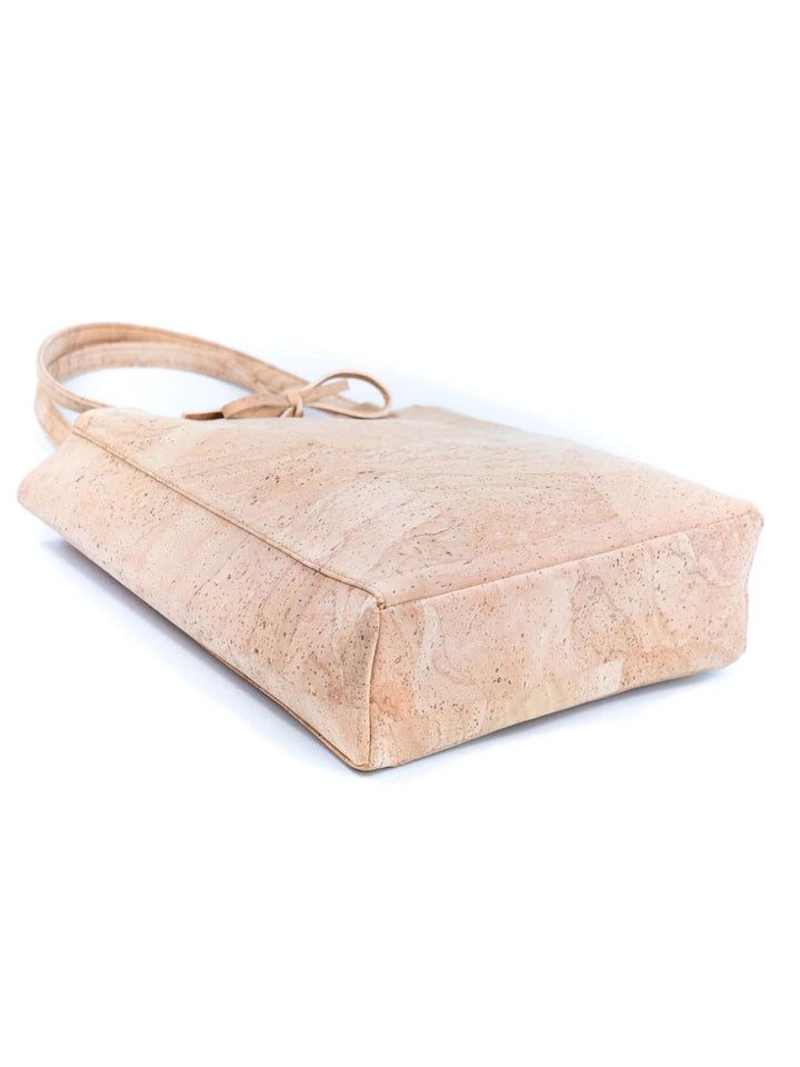 Beige handbag with a bow on a white background