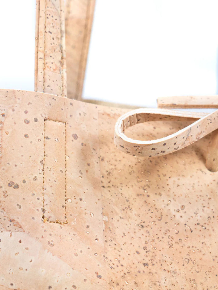 Close-up of a beige cork tote bag with visible texture.