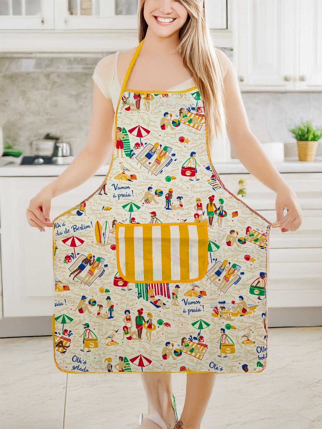 Person wearing a colorful apron with beach-themed design in a kitchen.