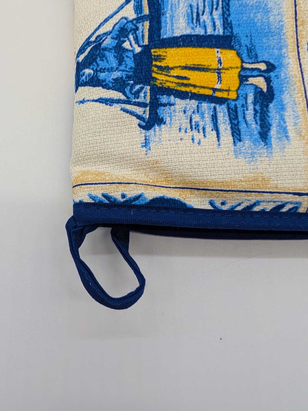 Potholder with blue and yellow design on a white background
