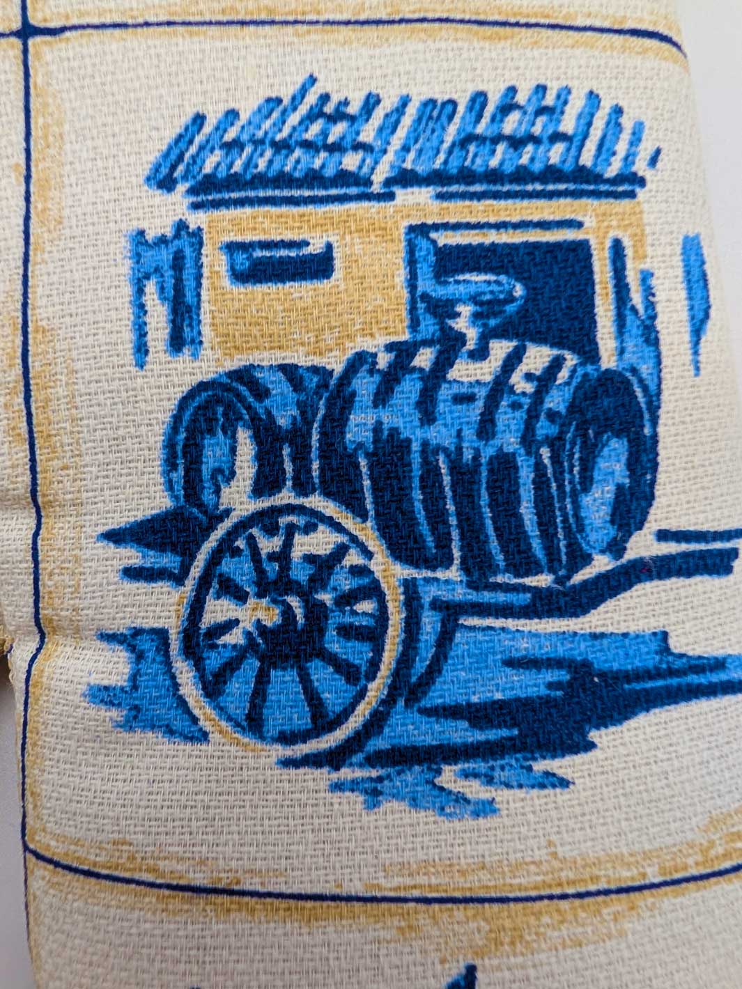 Napkin with blue tractor design on a beige background