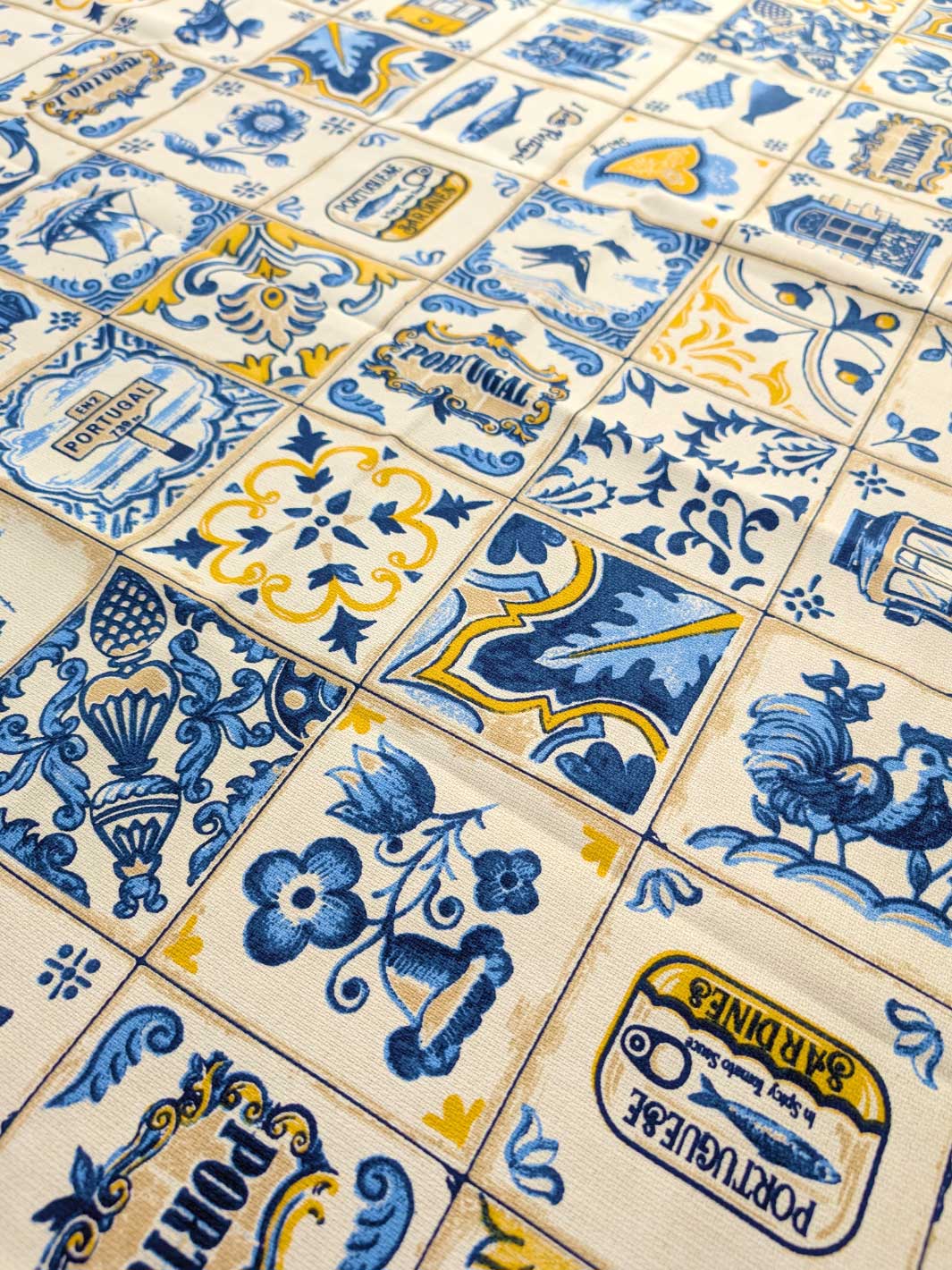 Pattern of blue and yellow tiles with decorative designs on a beige background