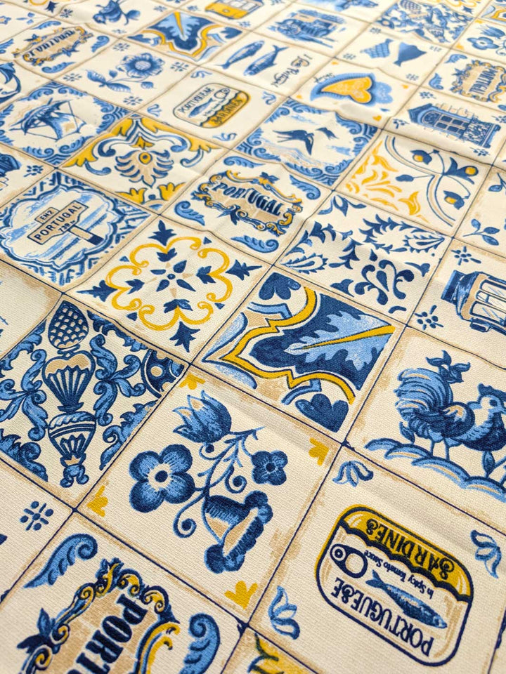 Pattern of blue and yellow tiles with decorative designs on a beige background