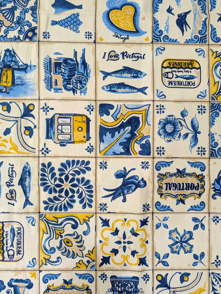 Pattern of blue and yellow tiles with various designs on a beige background