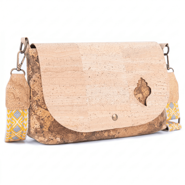 Cork handbag with a decorative strap on a white background