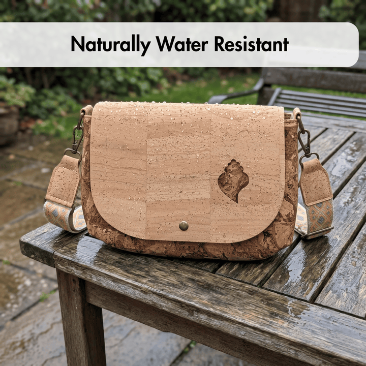 Cork handbag on a wet wooden table with 'Naturally Water Resistant' text.
