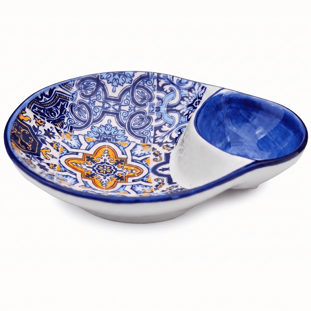 A ceramic two-compartment serving dish with a blue and orange floral pattern on the larger shallow bowl and a smaller deep blue bowl, shown on a white background.