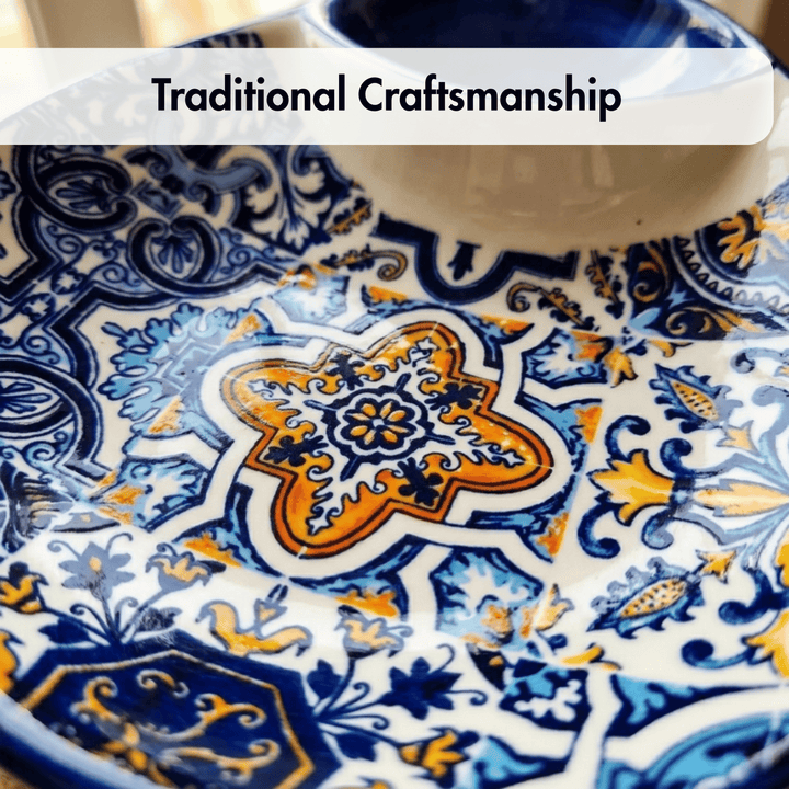 A close-up of a decorative ceramic plate with a traditional hand-painted pattern in blue, orange, and white. A white text banner at the top reads &