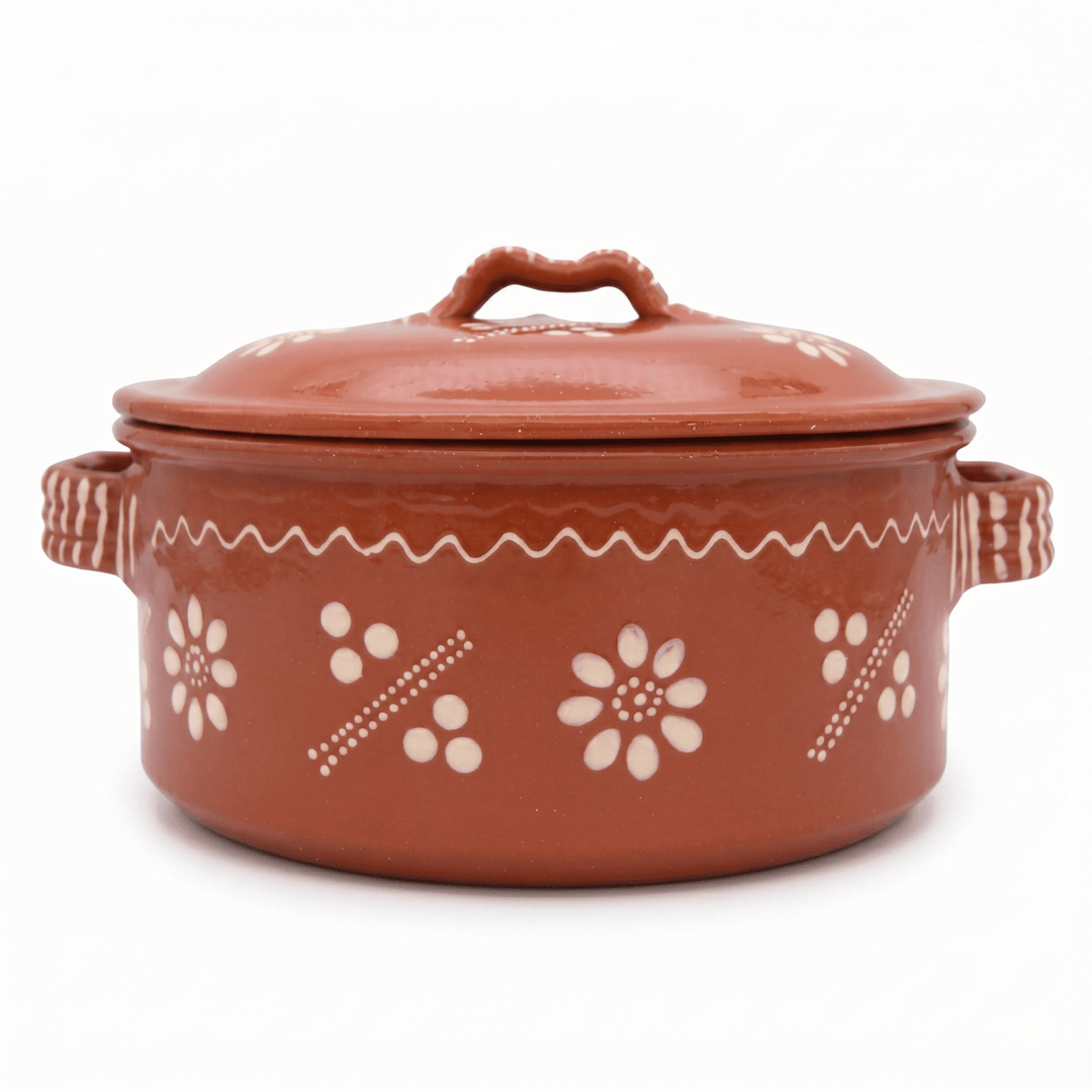 Terracotta pot with floral patterns on a white background