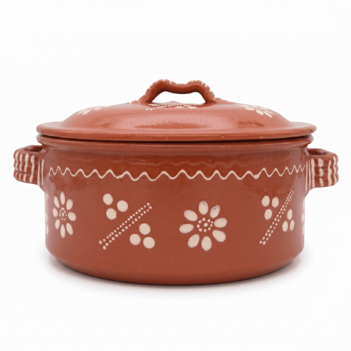 Terracotta pot with floral patterns on a white background