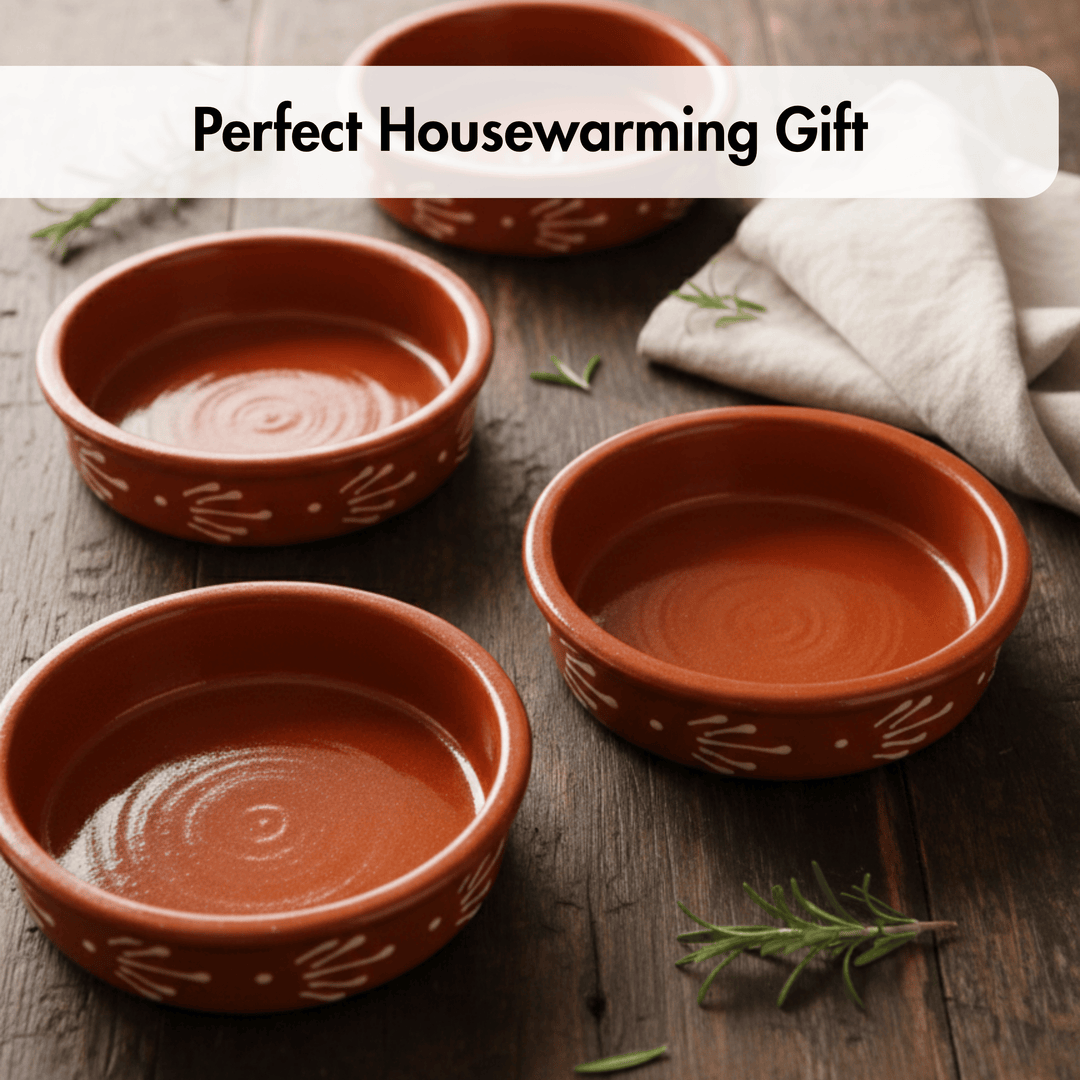 Three terracotta-colored ceramic bowls with white hand-painted leaf patterns are arranged on a dark wooden table with a white cloth and rosemary sprigs. A text banner at the top reads &