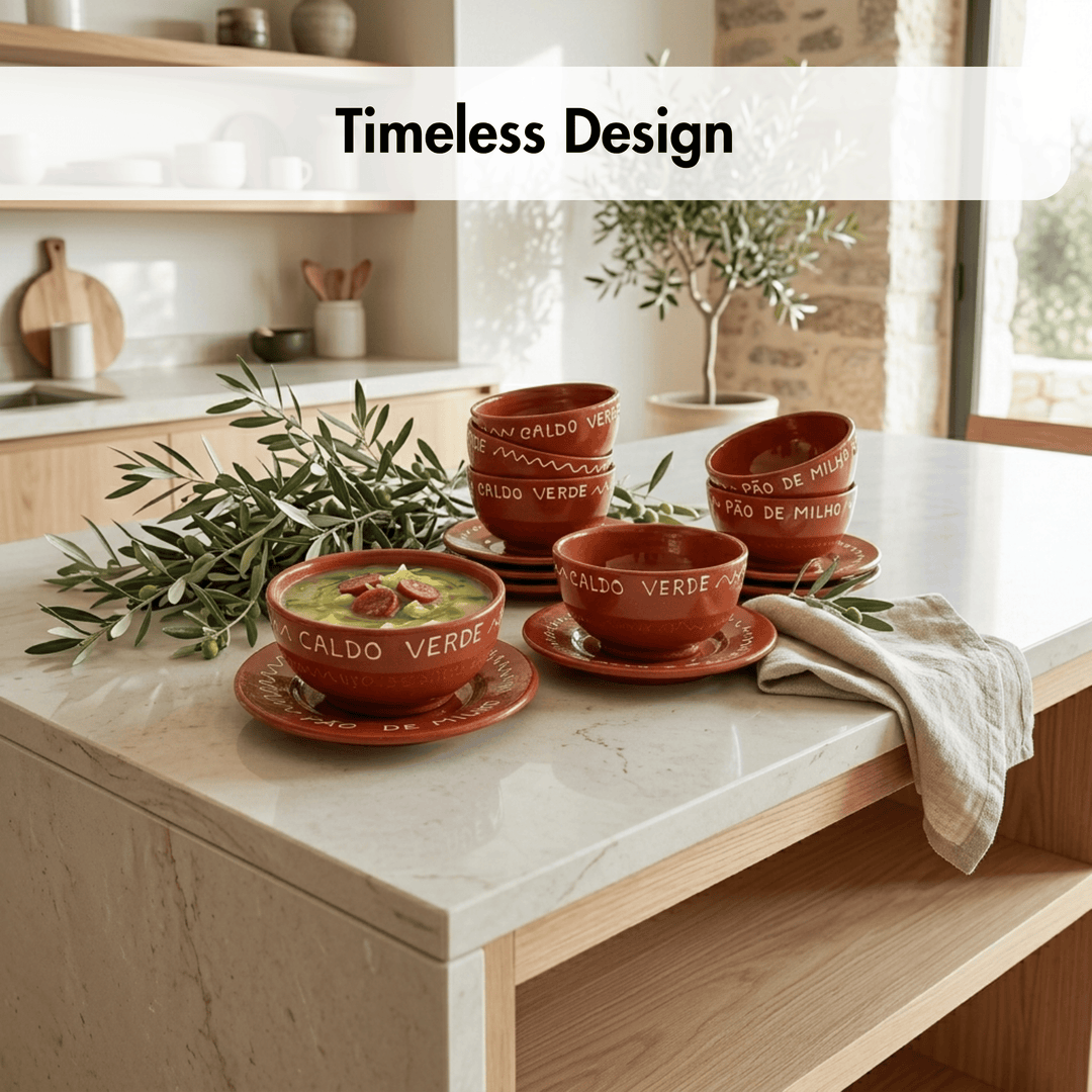 Terracotta-colored ceramic soup bowls and saucers with white text, styled on a marble kitchen countertop with olive branches, a folded napkin, and a bowl of green soup. A text overlay at the top reads &