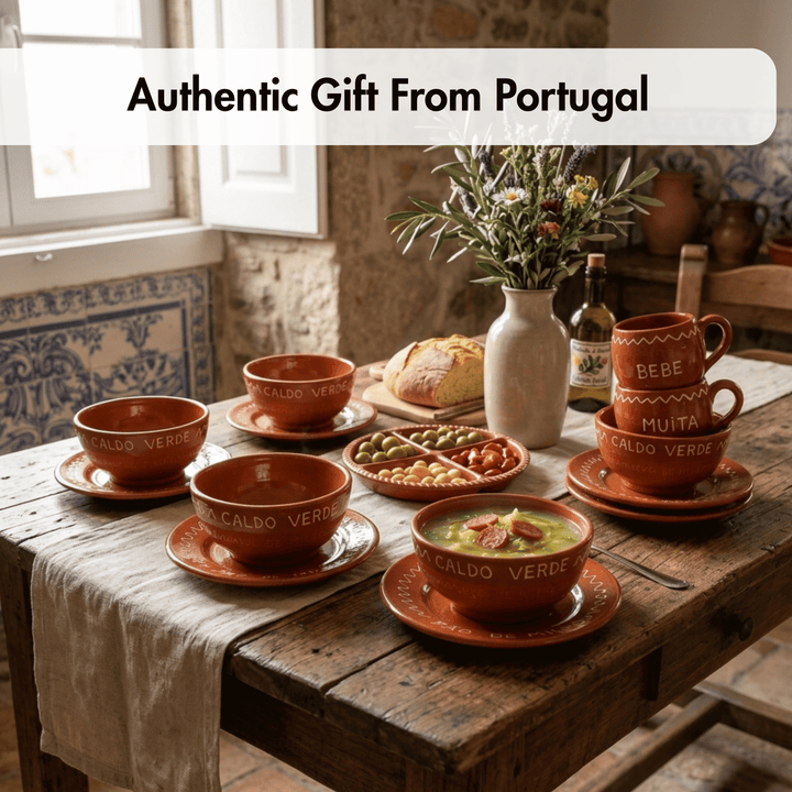 A rustic dining table set with multiple terracotta-colored ceramic tableware pieces from a Portuguese collection, including bowls, mugs, and plates, alongside a vase of flowers, bread, and a bottle of olive oil. A text overlay at the top reads &
