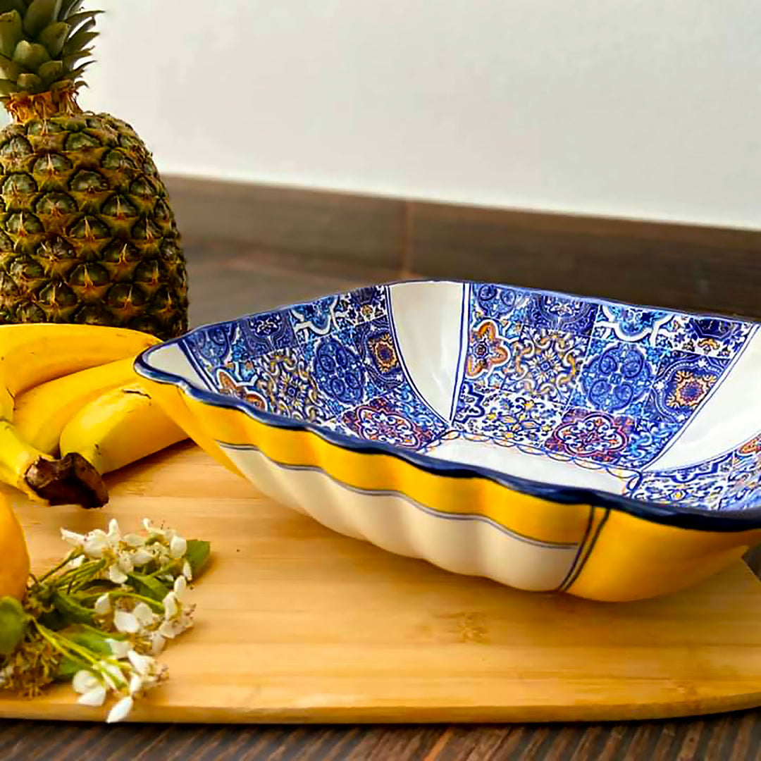 Hand painted portuguese ceramic salad bowl decorating a kitchen countertop.