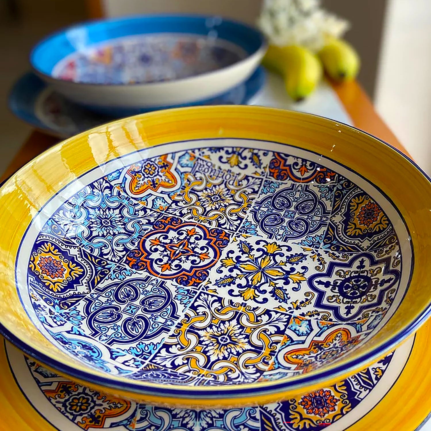 Portuguese ceramic round salad serving bowl with a colorful tiles patterns with yellow and blue shades.