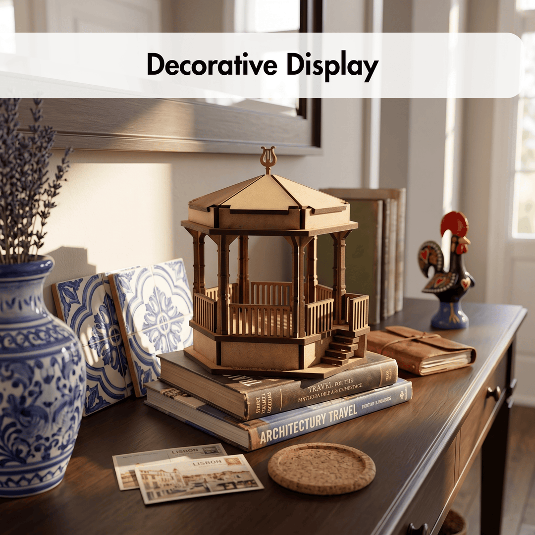A wooden gazebo model displayed on books on a wooden console table, with a blue-and-white ceramic vase, patterned coasters, and other home decor in a styled interior setting. A white banner at the top reads &