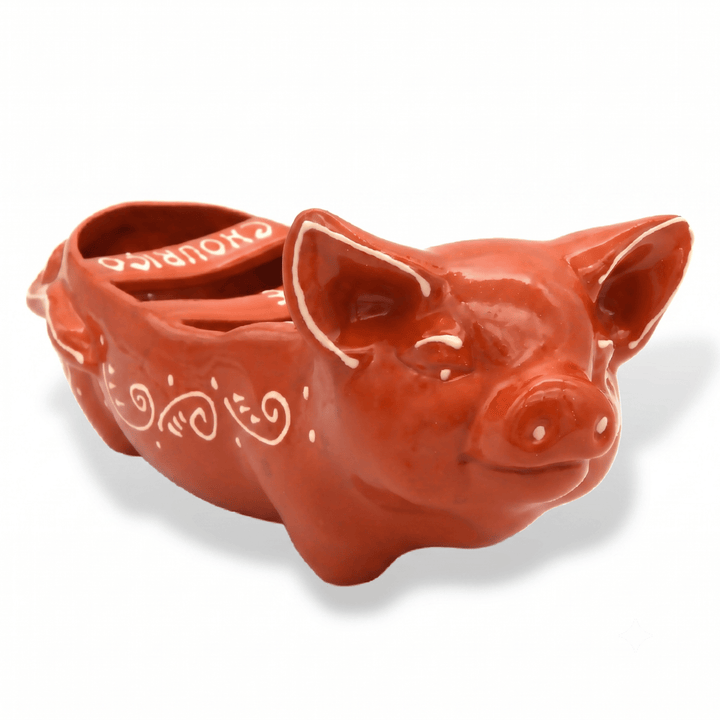 Ceramic pig-shaped container on a white background