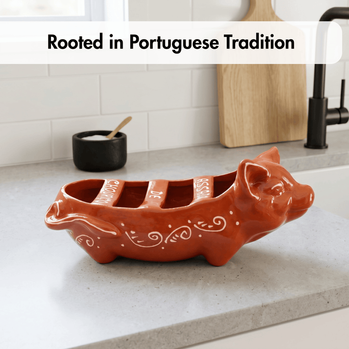 Ceramic pig-shaped dish on a kitchen counter with text 'Rooted in Portuguese Tradition'.