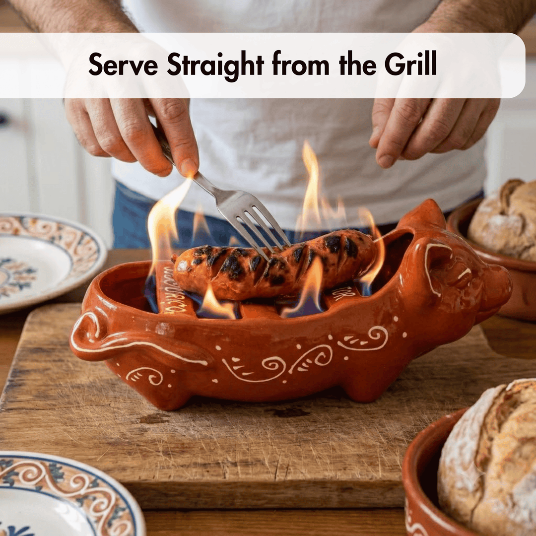 Person grilling a sausage in a decorative terracotta dish with flames.