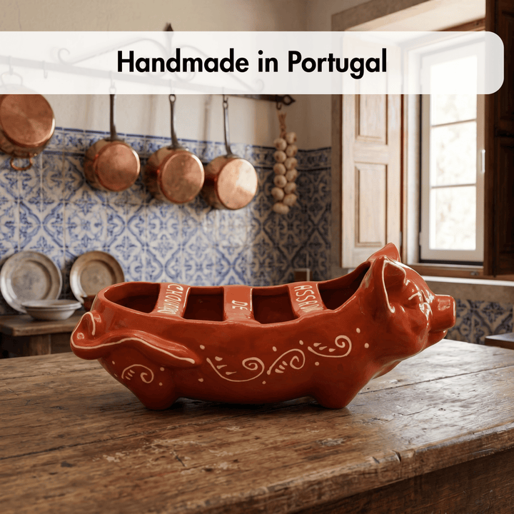 Handmade terracotta dish on a wooden table with a kitchen background in Portugal