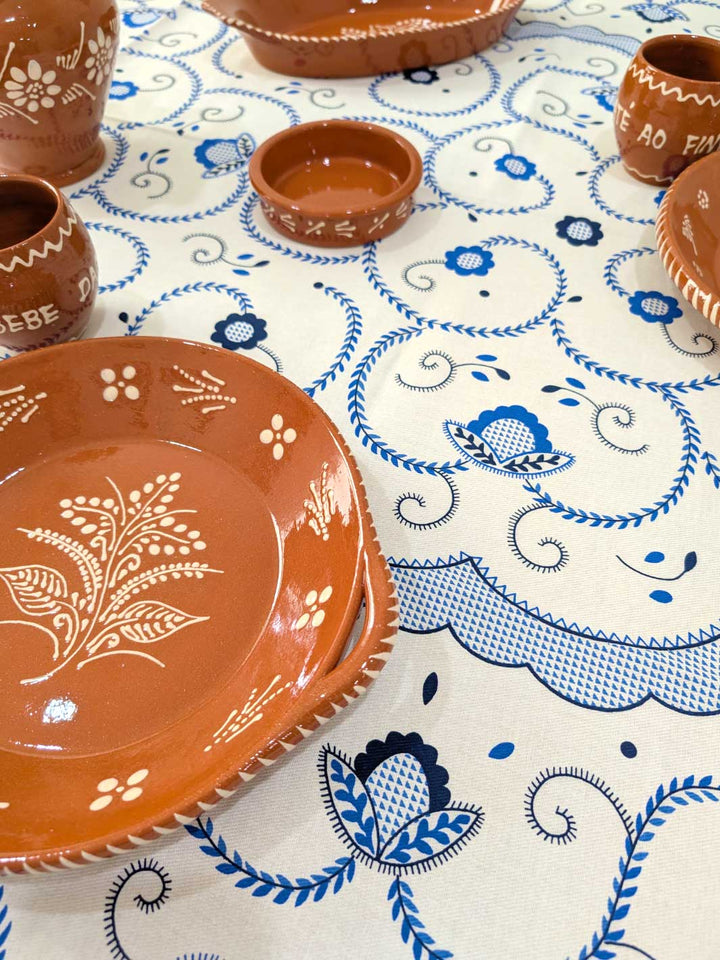 Ceramic plates and bowls on a tablecloth with blue and white patterns